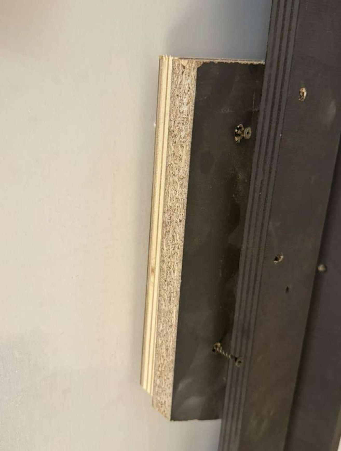 Particle board with screws
